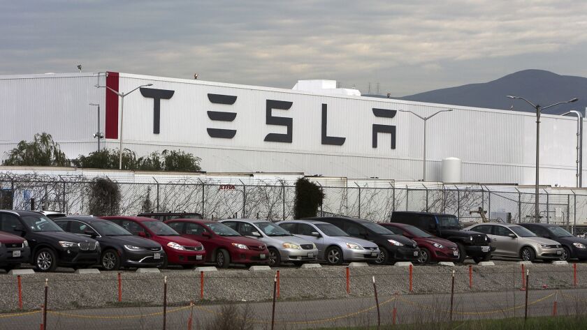 Cars are lined up near the Tesla Motors factory complex in Fremont, Calif., on Thursday, Jan. 28, 20