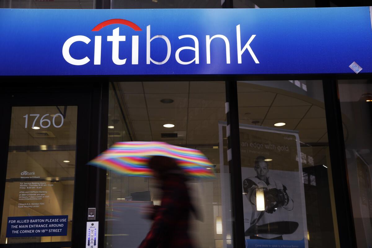 A person walks past a Citibank location in Philadelphia in this Jan. 14, 2014 file photo. Citibank, JP Morgan Chase Bank, Royal Bank of Scotland, HSBC Bank and UBS agreed to settlements totaling almost $3.4 billion for attempting to manipulate foreign exchange markets.