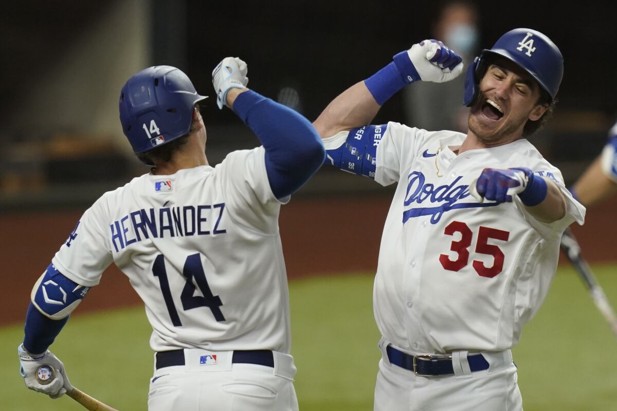 Cody Bellinger, right, celebrates with Kiké Hernández after hitting a solo home run for the Dodgers.