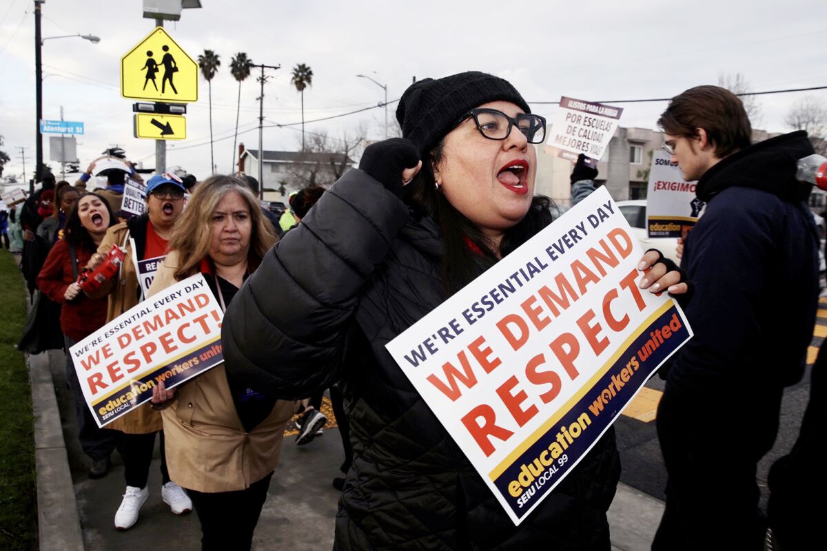 Striking LAUSD workers and their supporters rally in front of Avalon Gardens Elementary School on March 23.
