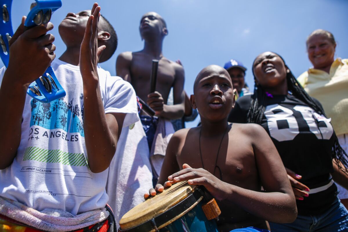 From left, Bulelani Ntame and Buhle Qamata sing and perform for fun at Santa Monica Beach.