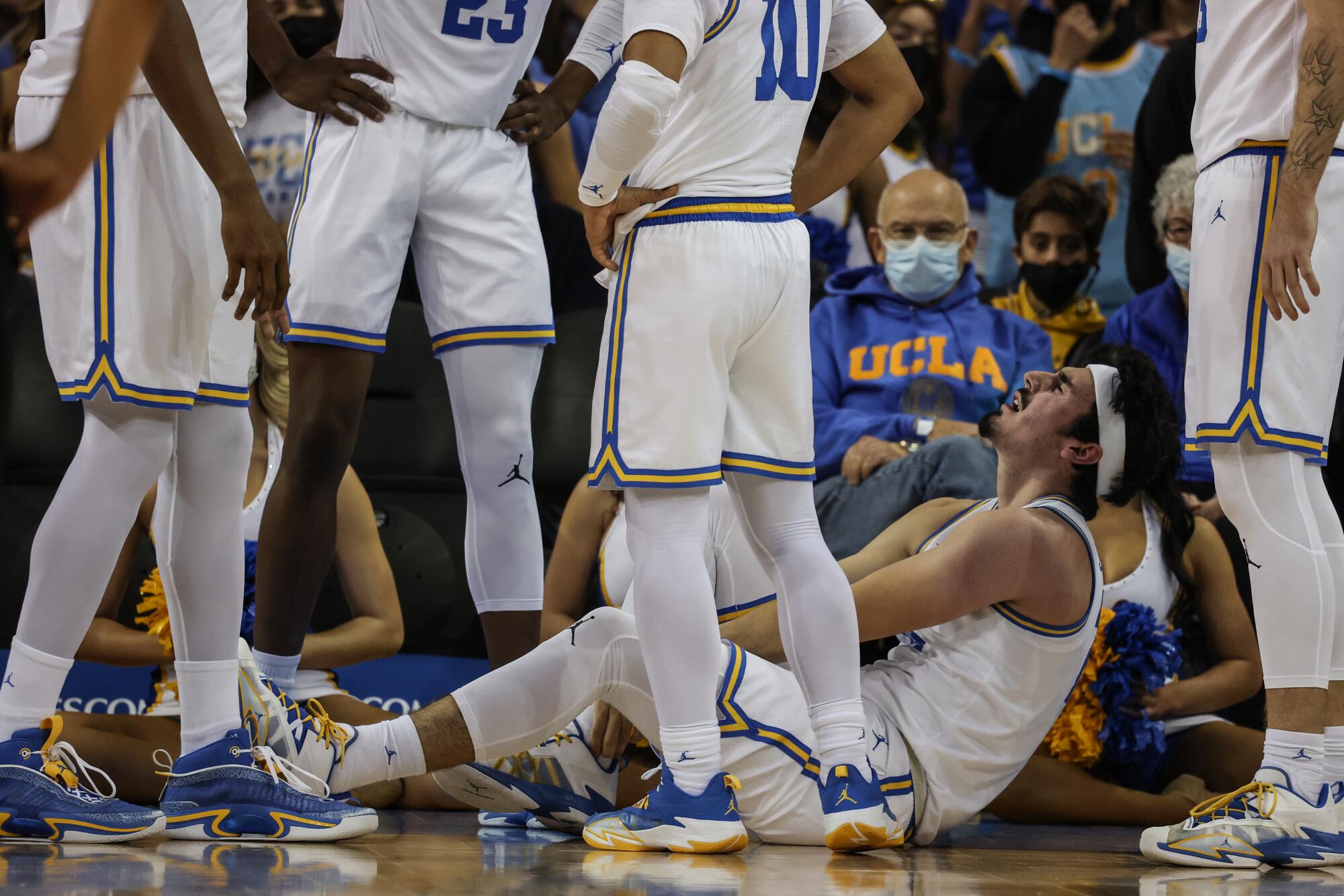 UCLA guard Jaime Jaquez Jr. writhes in pain after suffering an apparent ankle injury 