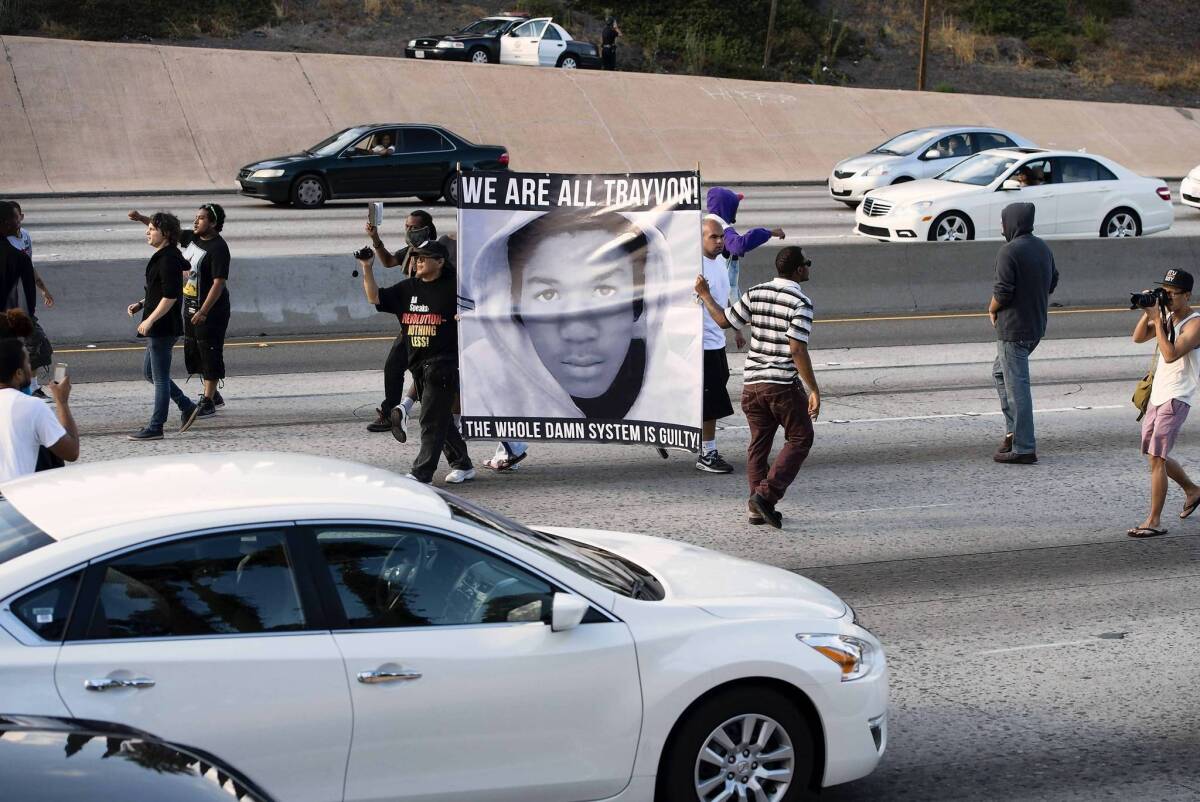 Protesters angry at the acquittal of George Zimmerman in the death of black teen Trayvon Martin walk onto the 10 Freeway, stopping highway traffic.