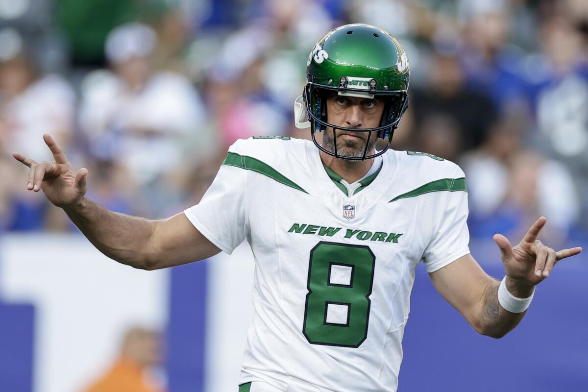 New York Jets quarterback Aaron Rodgers (8) sets up for a play. 