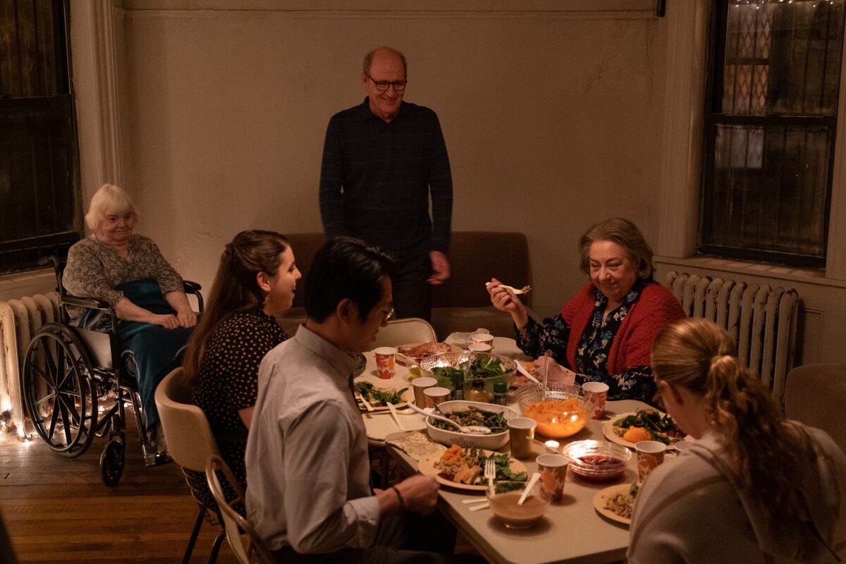 A family gathers around a table to eat in a scene from "The Humans."