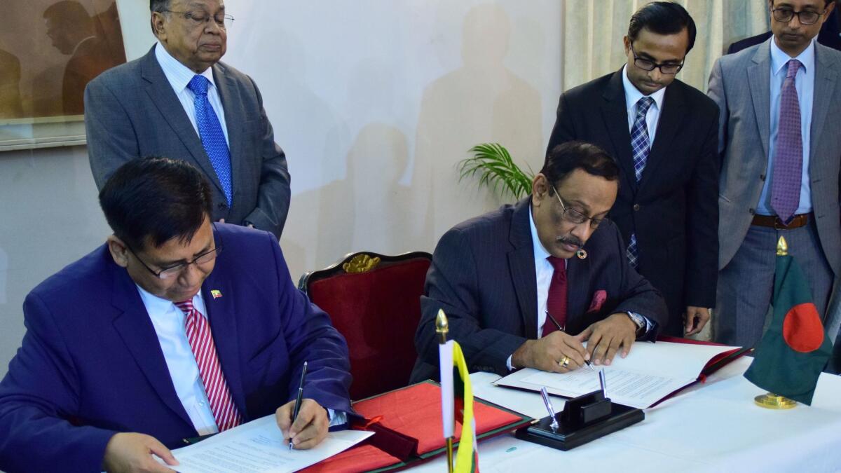 Bangladesh's Foreign Secretary Shahidul Haque, seated at right, and his Myanmar counterpart U Myint Thu reaffirm their commitment on Dec. 19 in Dhaka, Bangladesh, to begin repatriating Rohingya in January despite rights groups warning that their safety is still not assured.