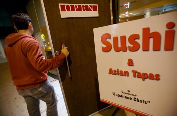 A sandwich board announces sushi and Asian tapas in front of BiMi, a 4-month-old restaurant in the Wilshire corridor between Barrington Avenue and Bundy Drive.