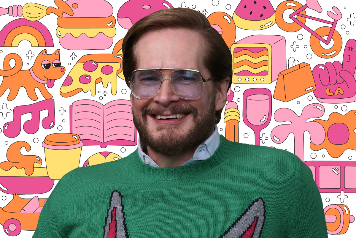 A man in glasses standing in front of a colorful background full of illustrations of a dog, pizza, book, bicycle and more