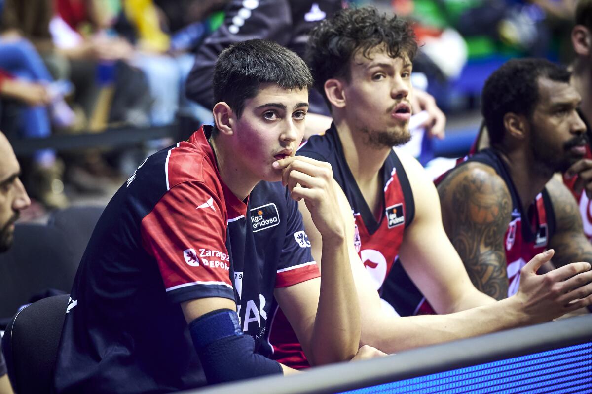 Aday Mara sits on the bench with teammates during a game in Spain in March.