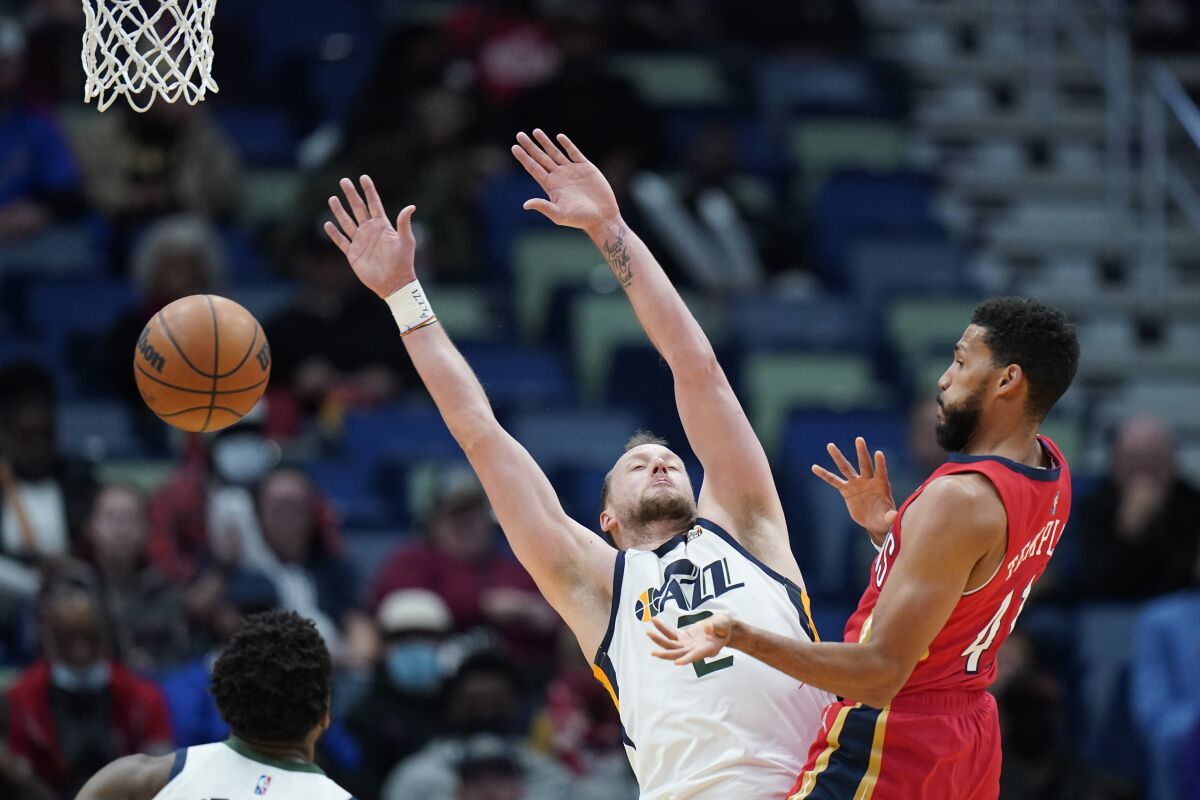 New Orleans Pelicans forward Garrett Temple (41) loses the ball as he drives to the basket against Utah Jazz guard Joe Ingles (2) in the second half of an NBA basketball game in New Orleans, Monday, Jan. 3, 2022. The Jazz won 115-104. (AP Photo/Gerald Herbert)