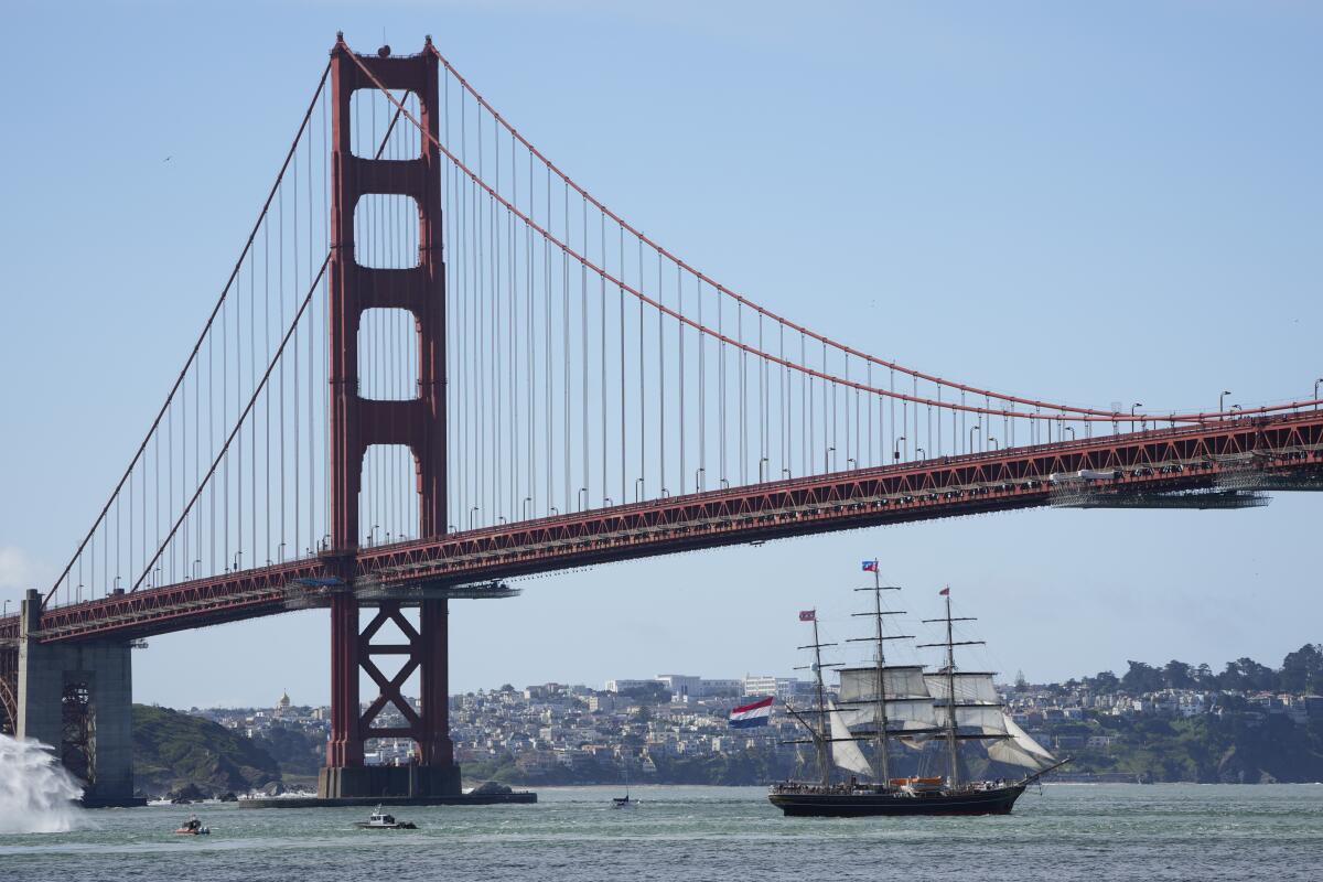 A tall ship sails under the Golden Gate Bridge