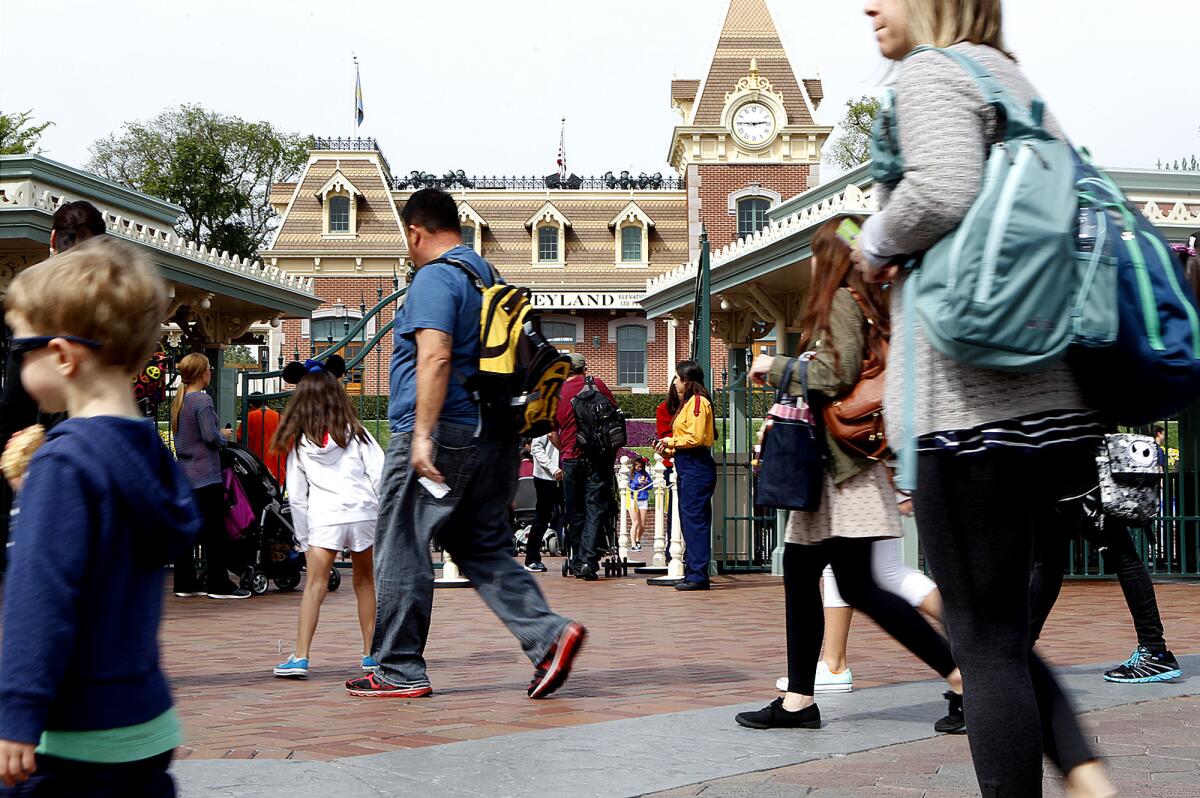 Visitors pass by the entrance gate to Disneyland. Walt Disney Parks & Resorts issued a survey that suggests the company is considering a new pricing schedule for daily tickets.