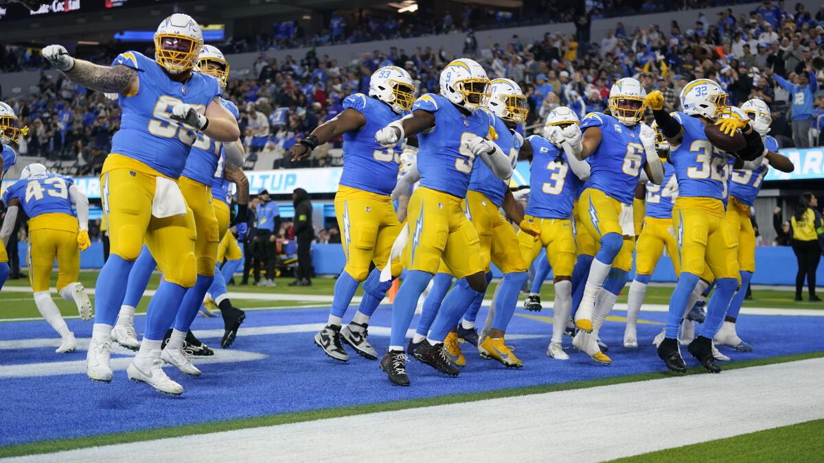 Chargers players celebrate after an interception by safety Alohi Gilman (32) in the third quarter.