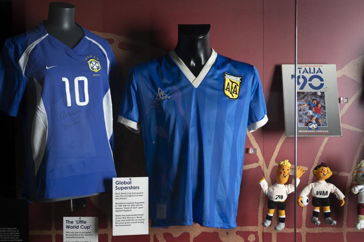 FILE - The soccer shirt, center, worn by Argentina's Diego Maradona in the 1986 World Cup quarterfinal against England is displayed at the National Football Museum in Manchester, England Nov. 26, 2020. The shirt worn by Diego Maradona when he scored the controversial “Hand of God” goal against England in the 1986 World Cup is for sale for the first time. Auctioneer Sotheby’s said Wednesday, April 6, 2022 that the jersey could fetch more than 4 million pounds ($5.2 million) in an online auction that opens April 20. (AP Photo/Jon Super, file)