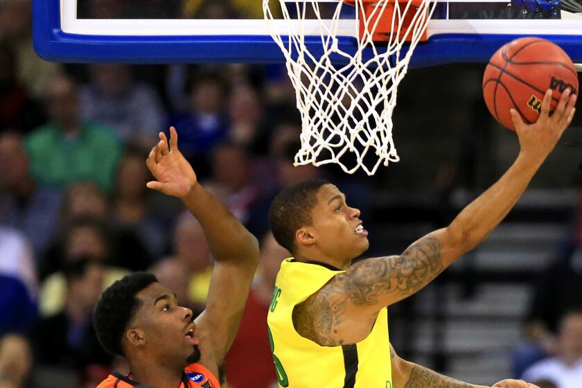 Oregon guard Joseph Young elevates past Oklahoma State forward Tavarius Shine in the second half of the Ducks' 79-73 victory Friday.