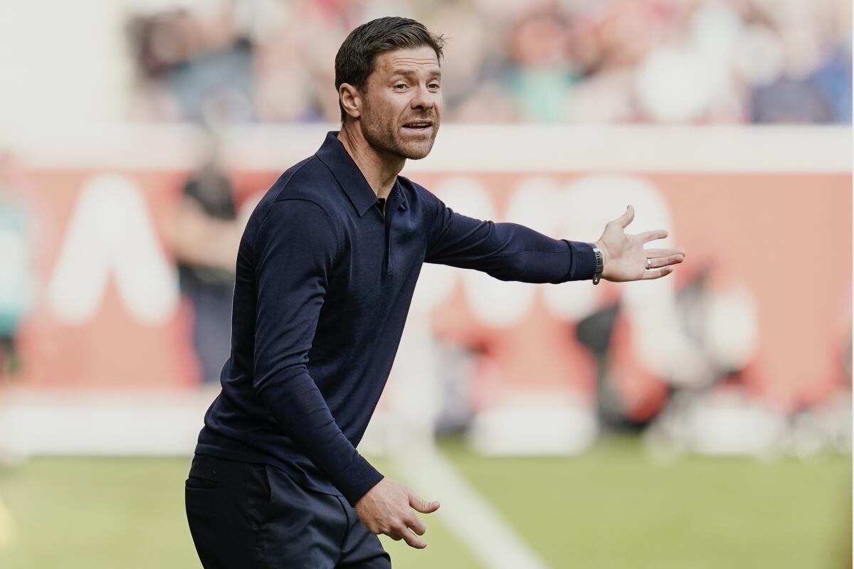 Leverkusen coach Xabi Alonso gives directions to his players during a German Bundesliga soccer match between FSV Mainz 05 and Bayer Leverkusen, at the Mewa Arena in Mainz, Germany, Saturday Sept. 30, 2023. (Uwe Anspach/dpa via AP)