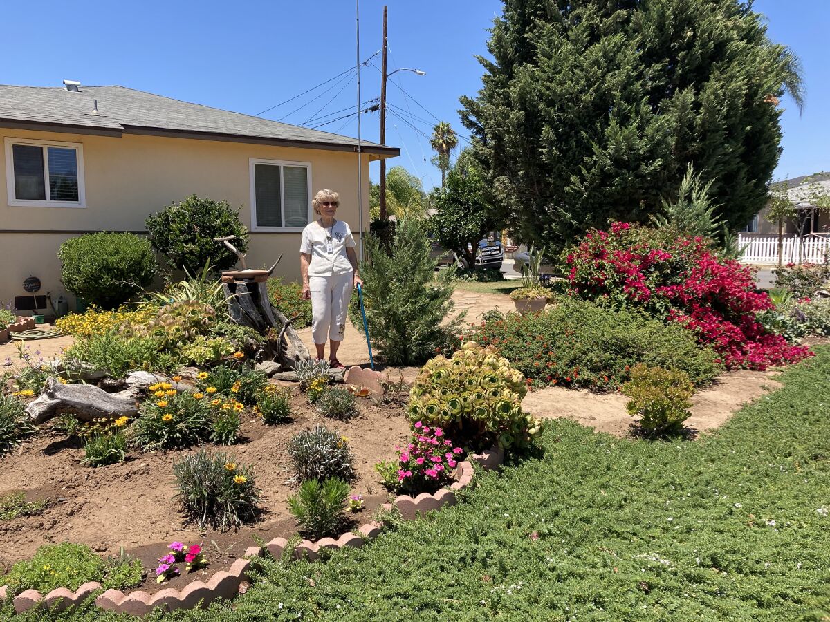 Homeowner Jeanne Reutlinger shows off her garden after being chosen the 2022 WaterSmart Landscape Contest winner.