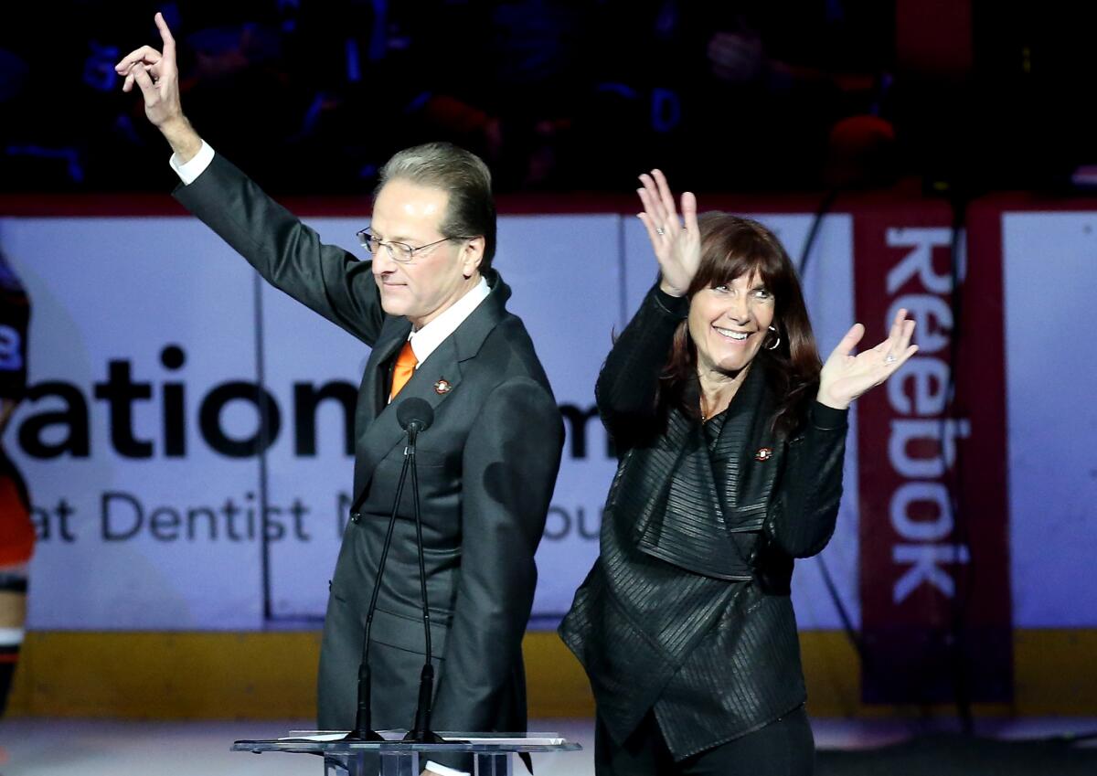 Ducks owners Henry and Susan Samueli acknowledge the crowd during Teemu Selanne's jersey retirement ceremony at Honda Center in January 2015.