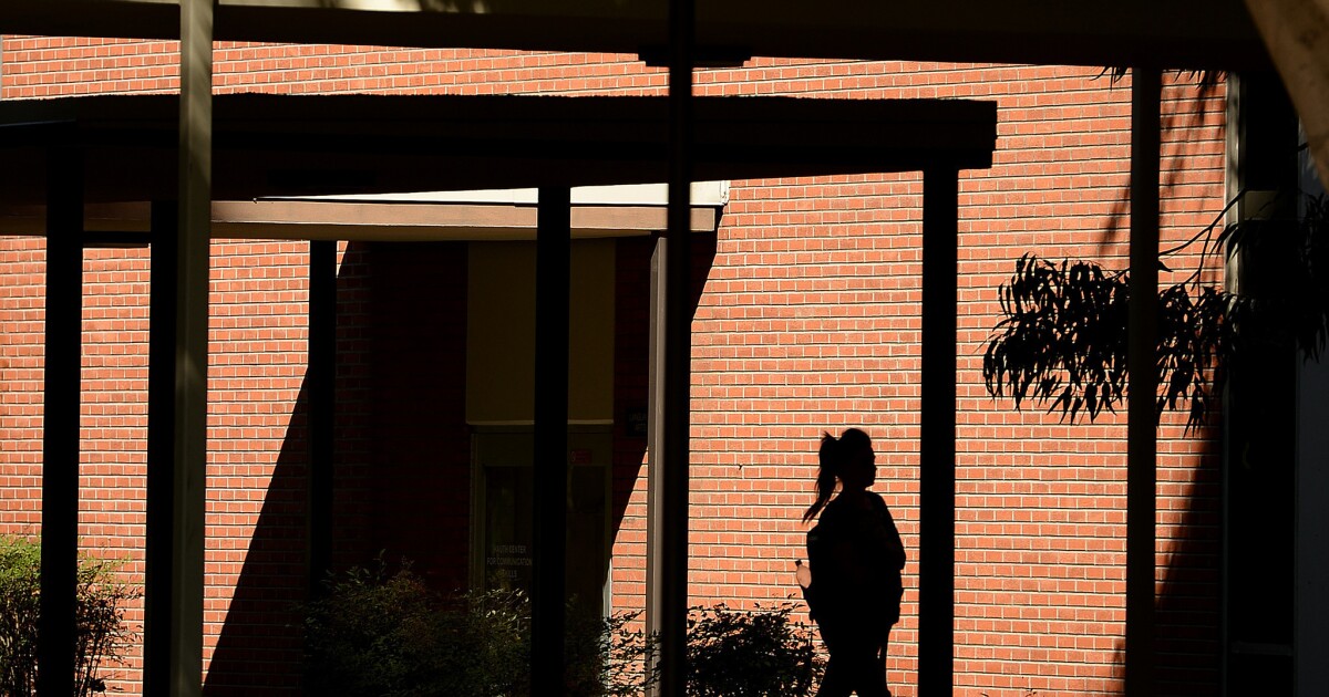 A student walks on campus at Cal State Long Beach.