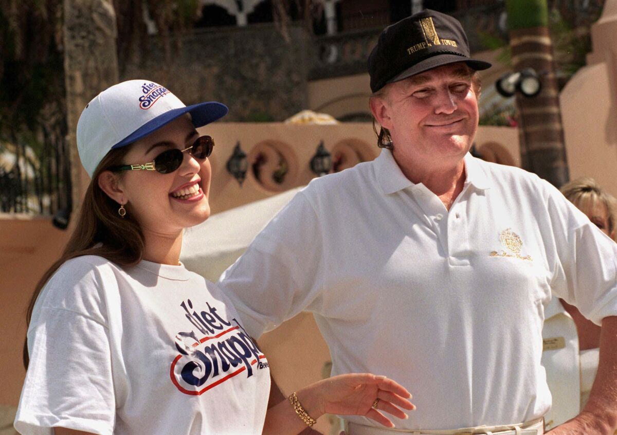 Miss Universe Alicia Machado, left, and Donald Trump chat at his Mar-a-Lago club in Palm Beach, Fla., on Feb. 15, 1997.