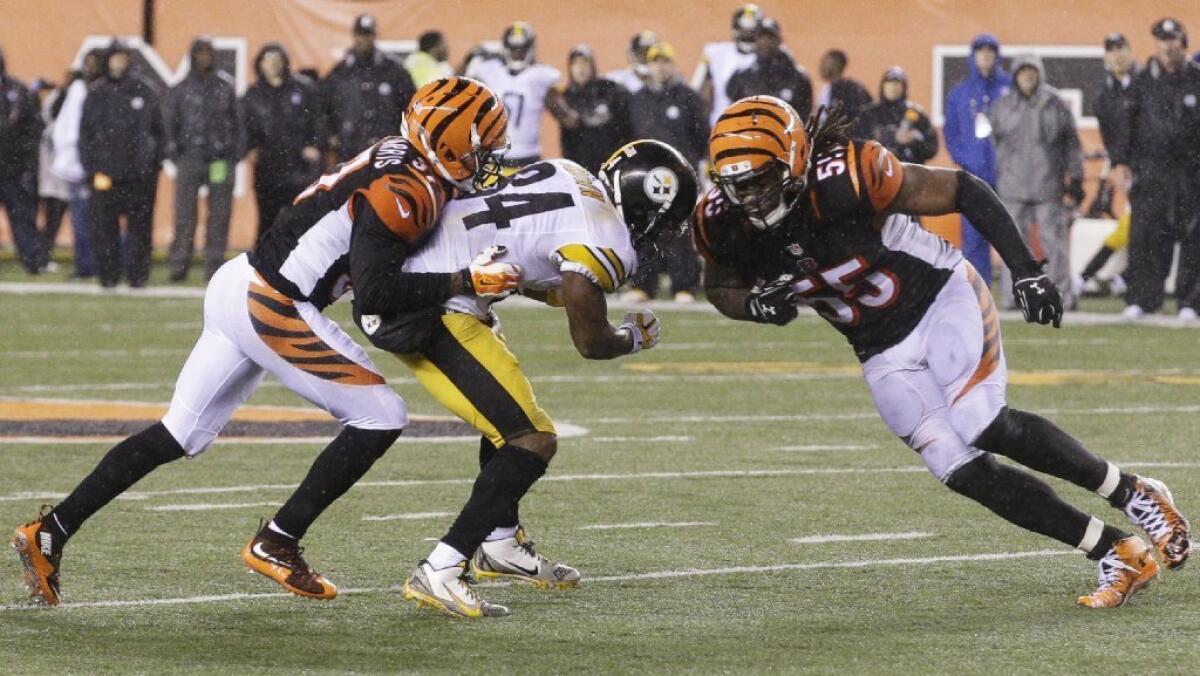 The Cincinnati Bengals' Vontaze Burfict (55) runs into the Pittsburgh Steelers' Antonio Brown (84) during an NFL wildcard game in January. Burfict was penalized on the play. A new study finds evidence that brain trauma could be widespread among former NFL players.