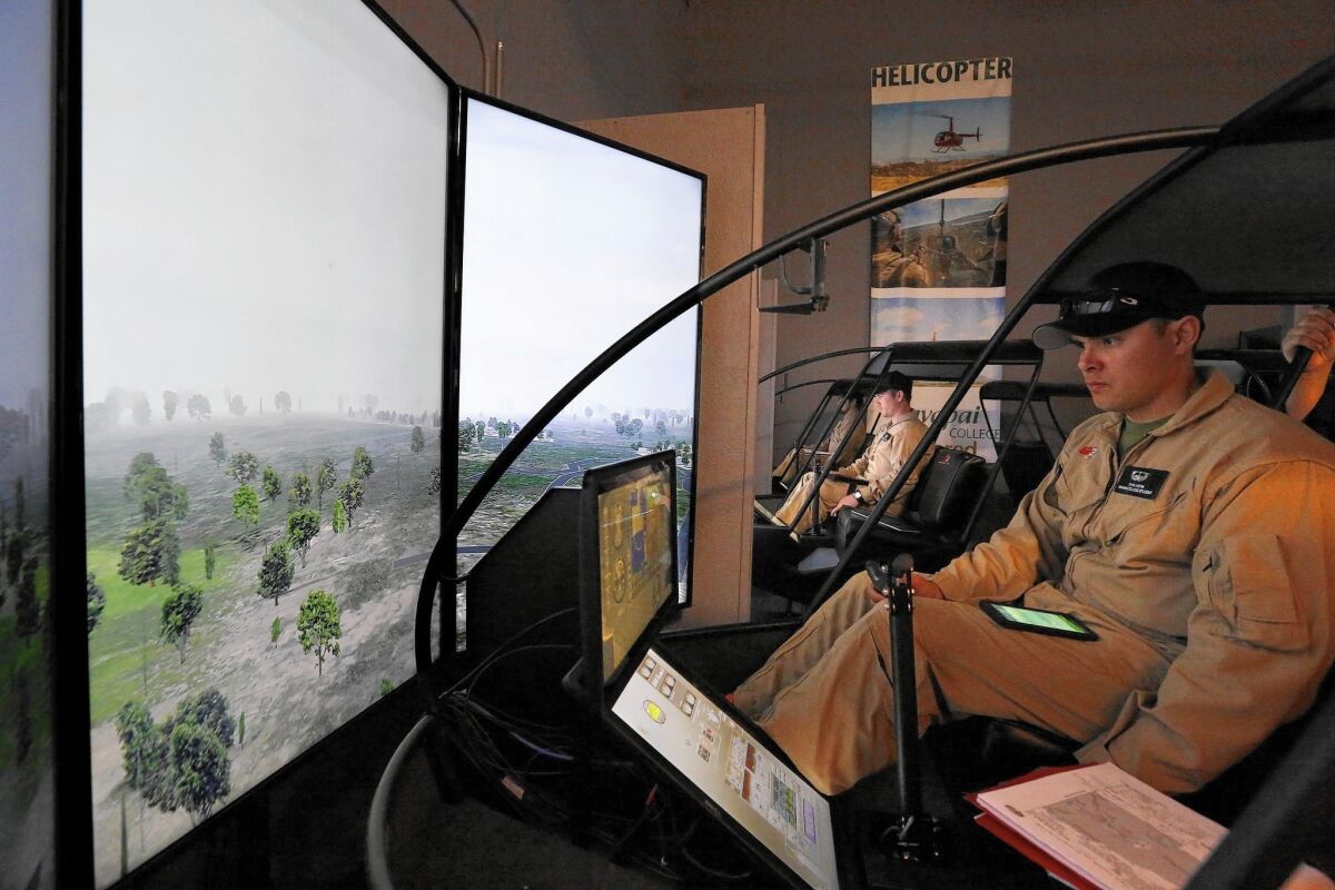 Marine Corps veteran Ryan Smith trains in a helicopter flight simulator at Yavapai College in Prescott, Ariz., under a government-funded program. The Department of Veterans Affairs has barred new enrollees in that program.