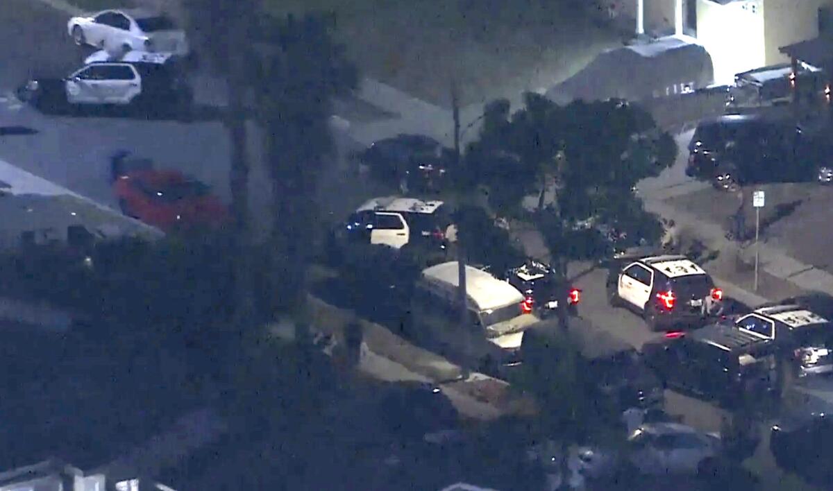 Police vehicles at the scene of a shooting in an unincorporated part of L.A. County near Compton.  
