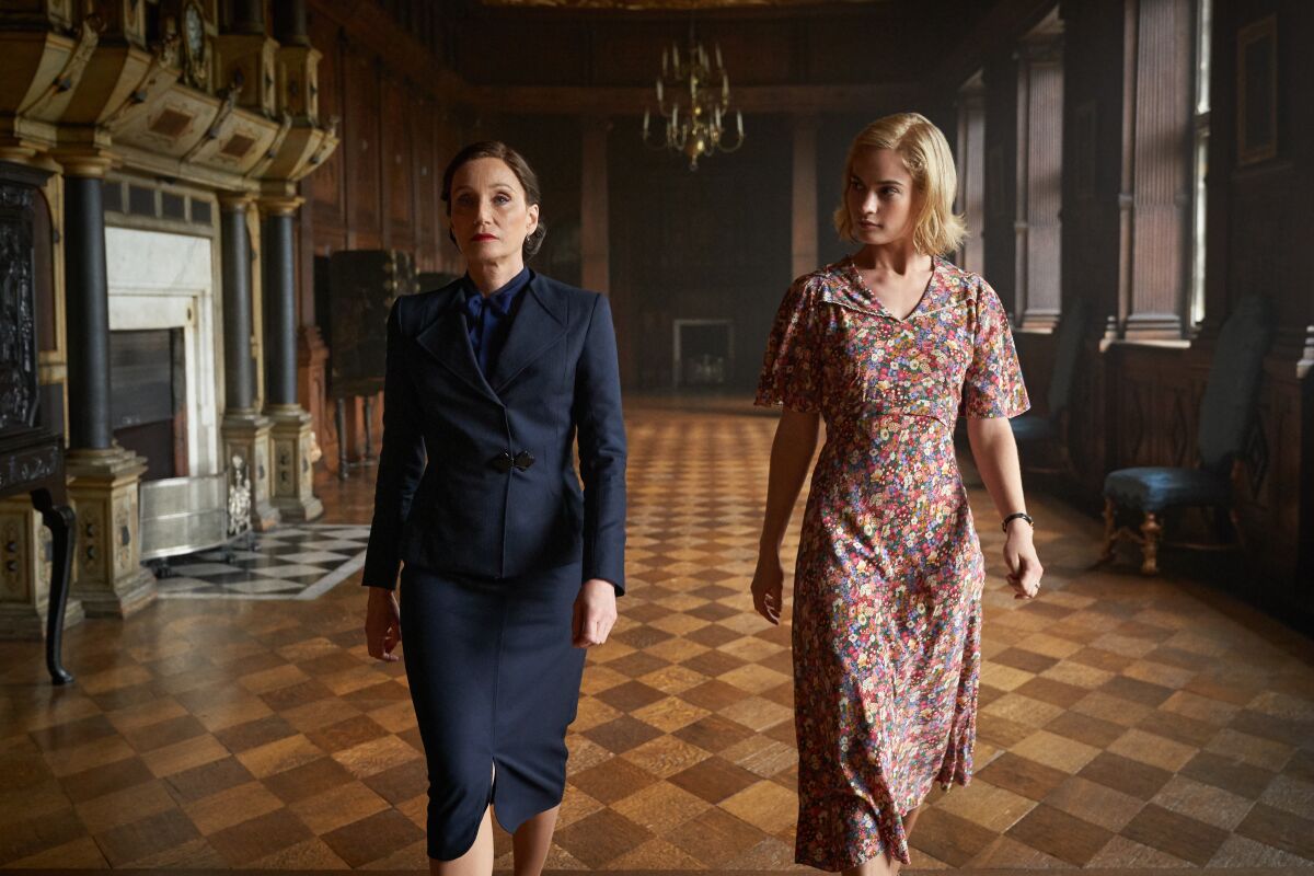 Kristin Scott Thomas as Danvers and Lily James as Daphne at the Manderley House in a scene from "Rebecca."