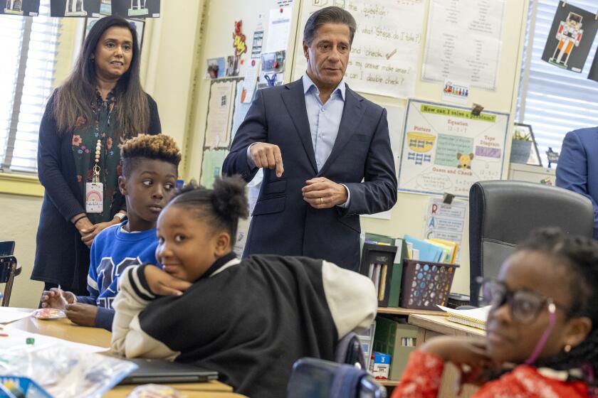 Carson, CA - December 18: Los Angeles Unified Superintendent Alberto M. Carvalho talks with student as he visits a Winter Academy program classroom at Carson Street Elementary School on Monday, Dec. 18, 2023 in Carson, CA. (Brian van der Brug / Los Angeles Times)
