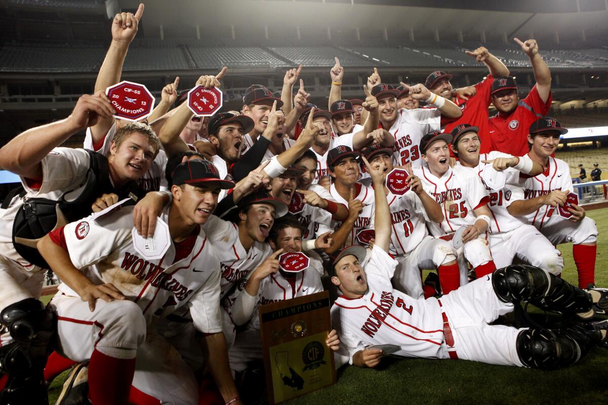 Harvard-Westlake celebrates their victory in the Southern Section Division 1 championship game at Dodger Stadium.