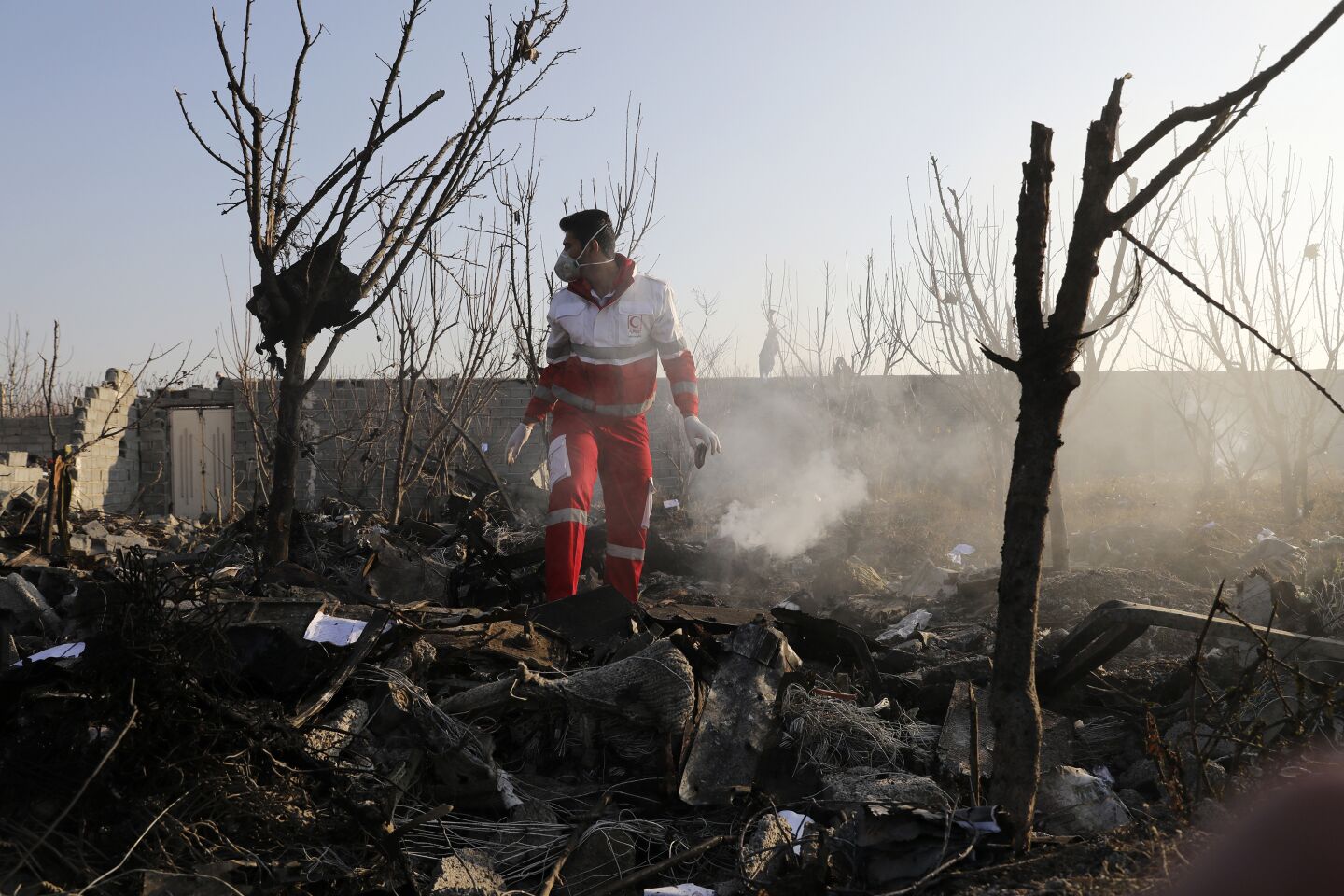 A rescue worker searches the scene of the plane crash. The aircraft never made it above 8,000 feet in the air, according to data from the flight-tracking website FlightRadar24.