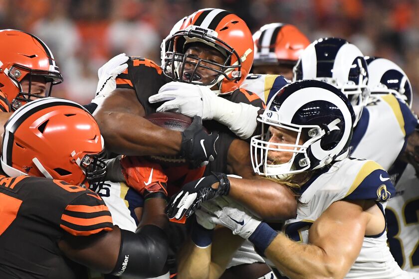 CLEVELAND, OHIO SEPTEMBER 22, 2019-Browns running back Nick Chubb is stopped by the Rams defense including Clay Matthews, right, in the 1st quarter at First Energy Stadium in Cleveland Sunday. (Wally Skalij/Los Angeles Times)