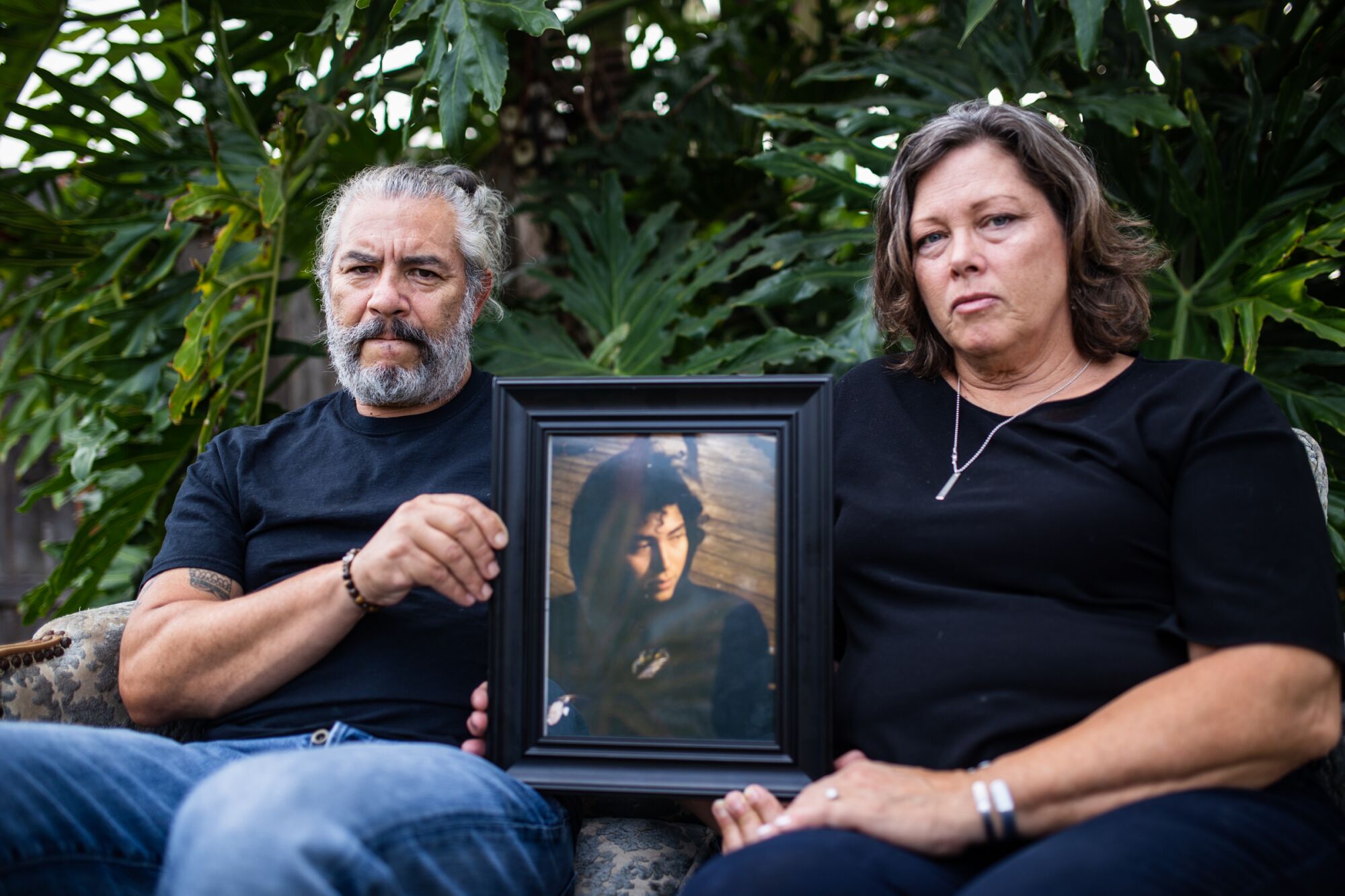 Antonio and Lisa Nava pose with a photograph of their 24-year-old-son, Alex Nava, who passed away from drug overdose