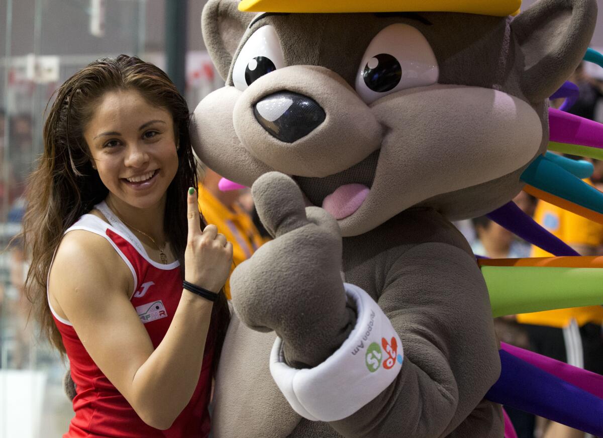 Mexico's Paola Longoria poses with Patchi, the Pan Am Games mascot, as she celebrates after winning gold in women's racquetball team competition at the Pan Am Games in Toronto, Sunday, July 26, 2015. (AP Photo/Rebecca Blackwell)