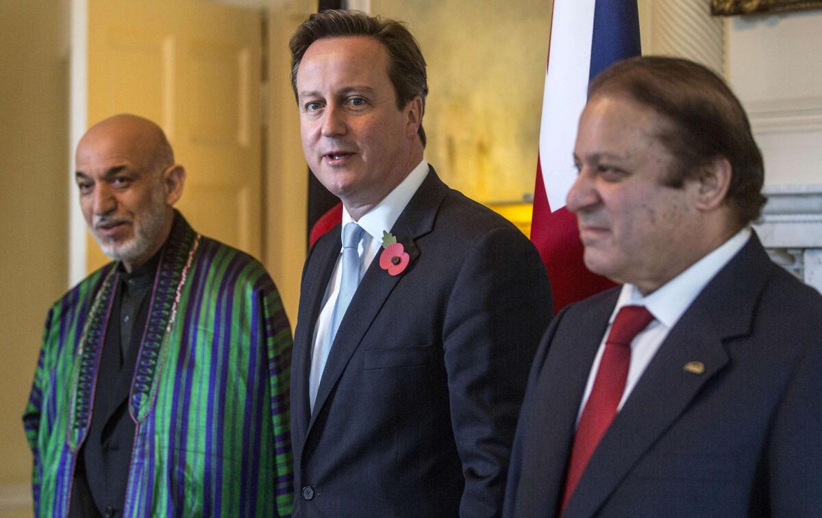 British Prime Minister David Cameron, center, Afghan President Hamid Karzai, left, and Pakistani Premier Nawaz Sharif pose for pictures ahead of a trilateral meeting in London on Tuesday.