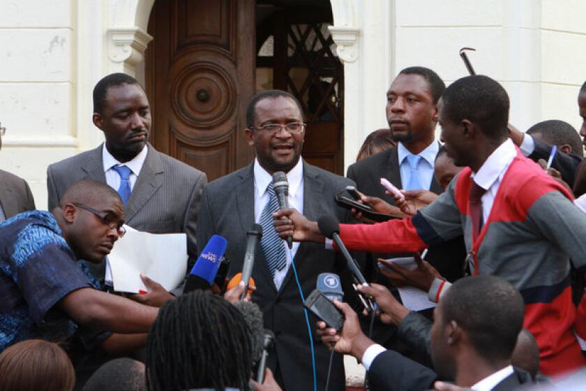 Opposition Movement For Democratic Change spokesman Douglas Mwonzora, center, addresses journalists outside the Constitutional Court in Harare, Zimbabwe. Lawyers for party leader Morgan Tsvangirai filed an appeal with the court against recent election results.