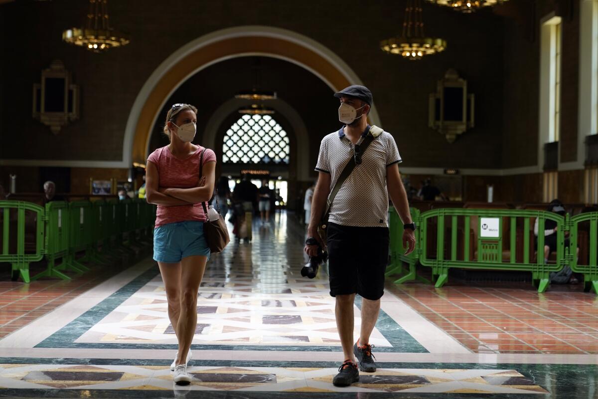 Visitors wears masks inside Union Station in Los Angeles.  