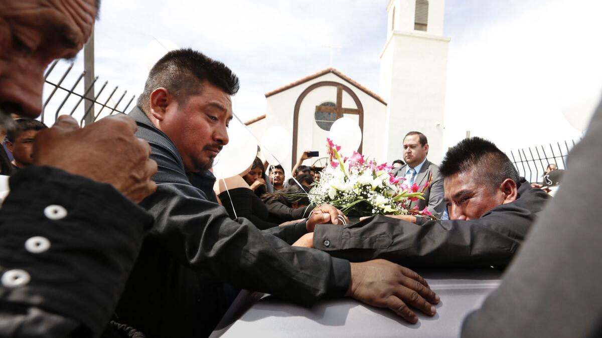 Funeral services are held for Santos Hilario Garcia and Marcelina Garcia Profecto at Our Lady of Guadalupe Church in Delano, Calif., on April 2.