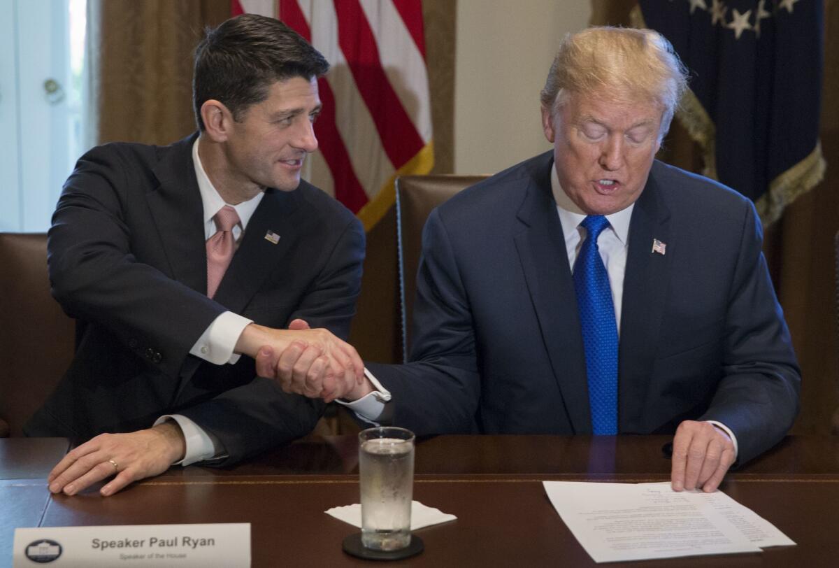 President Trump and House Speaker Paul D. Ryan (R-Wis.) shake hands on the GOP tax plan Thursday at the White House.