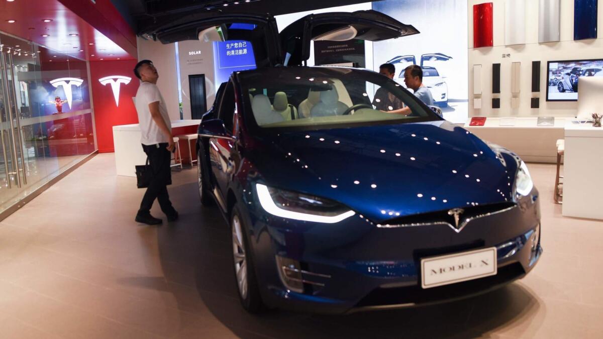 A man visits a Tesla showroom in Beijing on July 4.