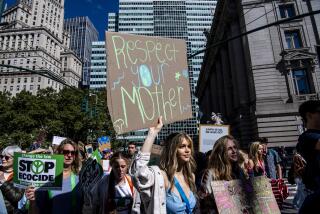 Activists walk through lower Manhattan for the Global Climate Strike protests, Friday, Sept. 23, 2022, in New York. (AP Photo/Brittainy Newman)