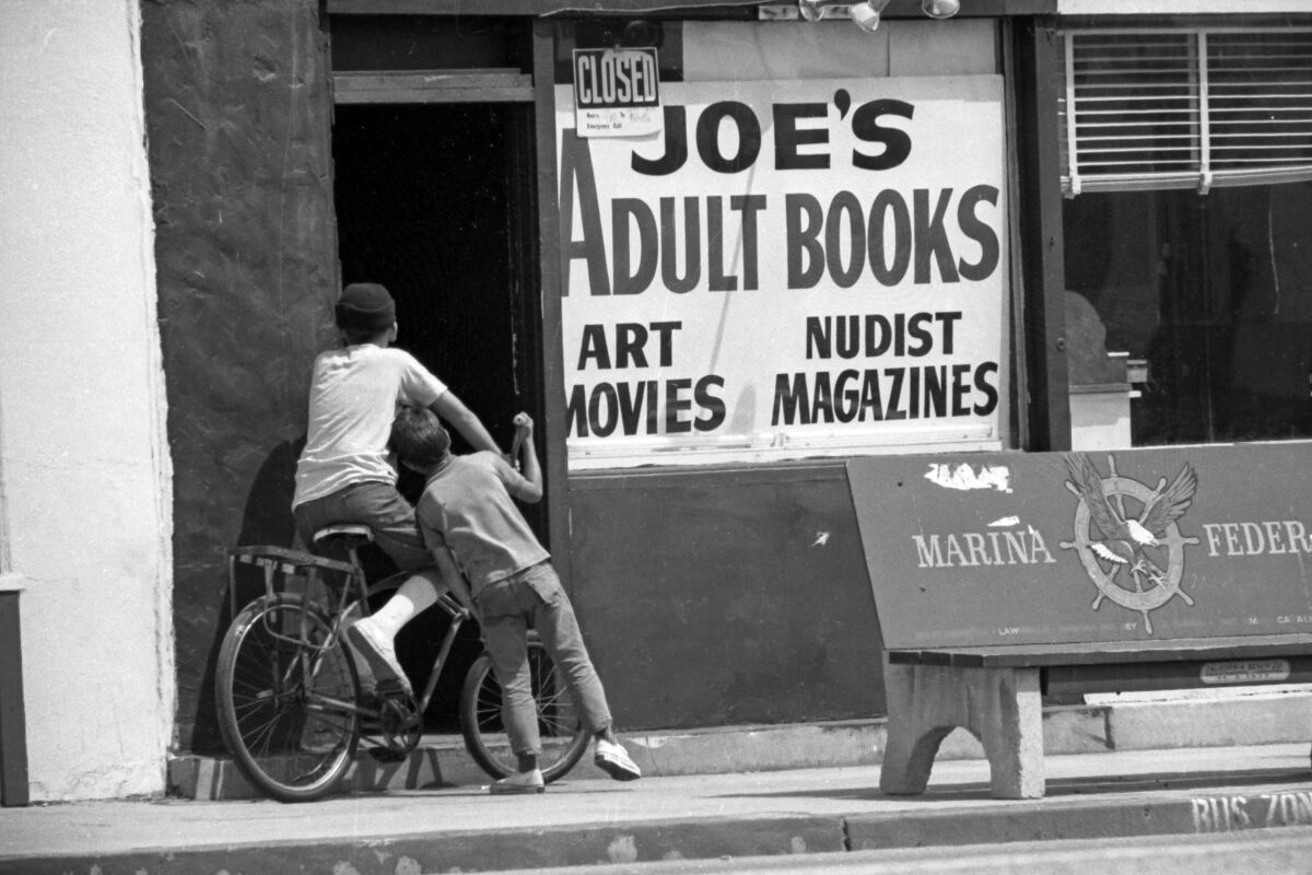 Two boys stop to investigate an adult book store in Lennox in August 1969. 