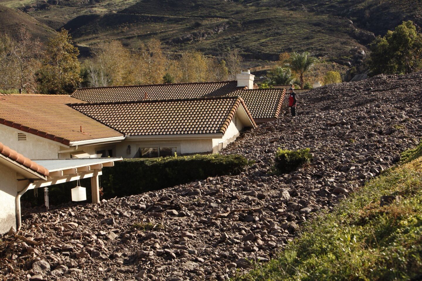 Homes on San Como Lane are buried to their roof by the debris flow in Camarillo Springs.