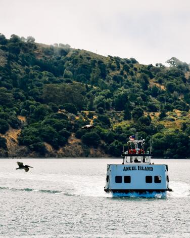 A boat with the words Angel Island sits on the bay.