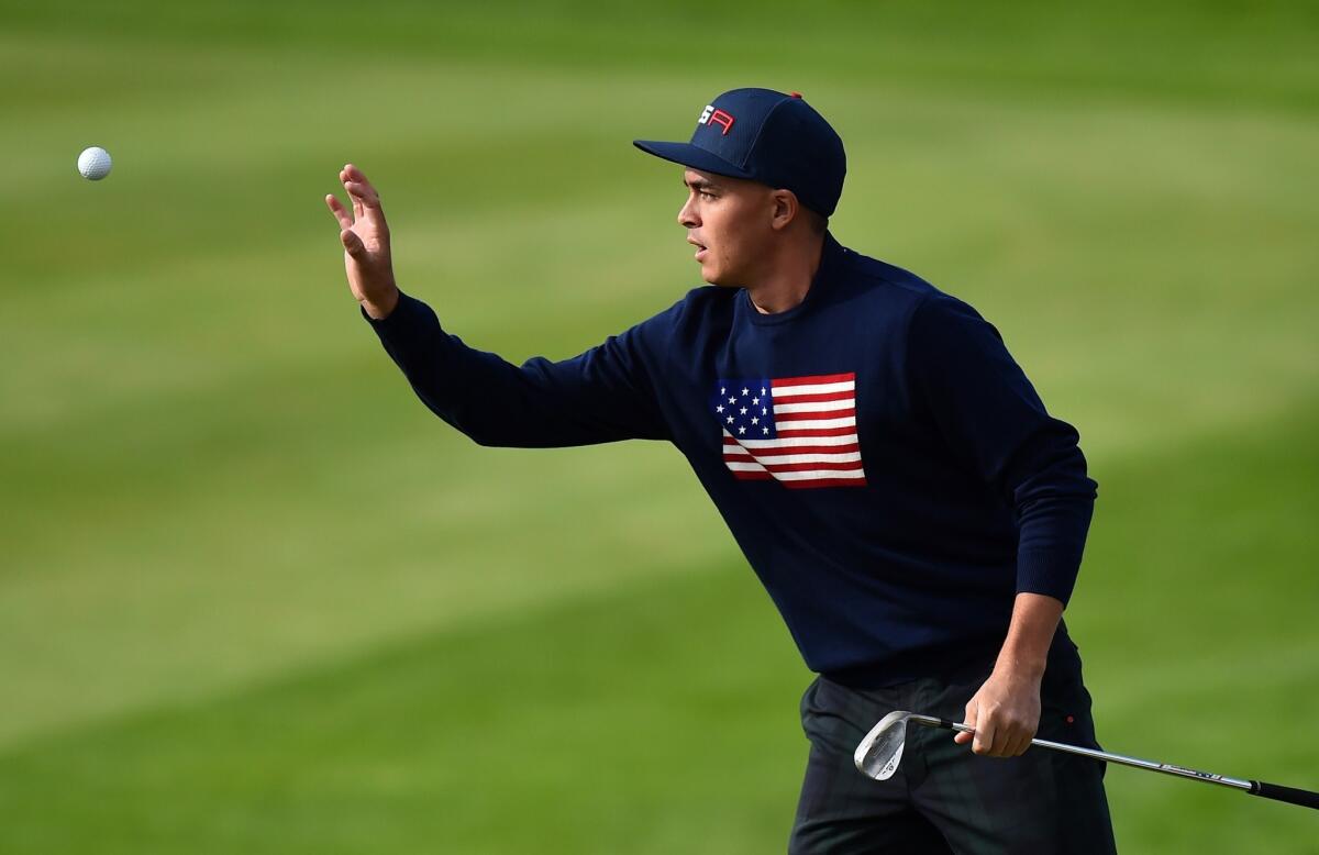 U.S. golfer Rickie Fowler catches a ball after pitching for birdie on the 10th hole during Saturday's fourball matches of the Ryder Cup at Gleneagles, Scotland.