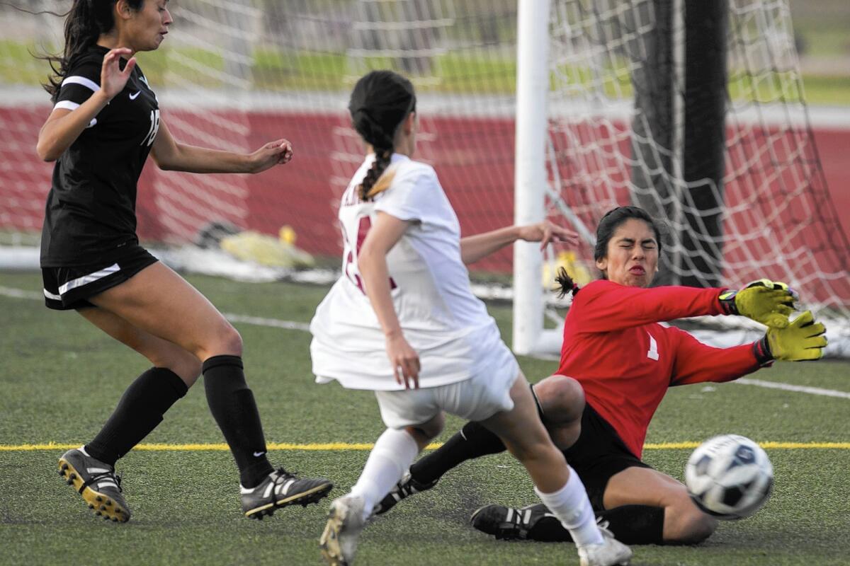 Estancia High's Emily Rodriguez has a shot blocked by Pacifica goalie Liz Cruz-Martinez during a second-round match of the CIF Southern Section Division 5 playoffs on Tuesday.