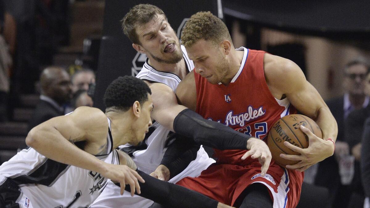 Clippers forward Blake Griffin, center, is pressured by San Antonio Spurs teammates Danny Green, left, and Tiago Splitter during the Spurs' 100-73 victory in Game 3 of the NBA Western Conference quarterfinals Friday.