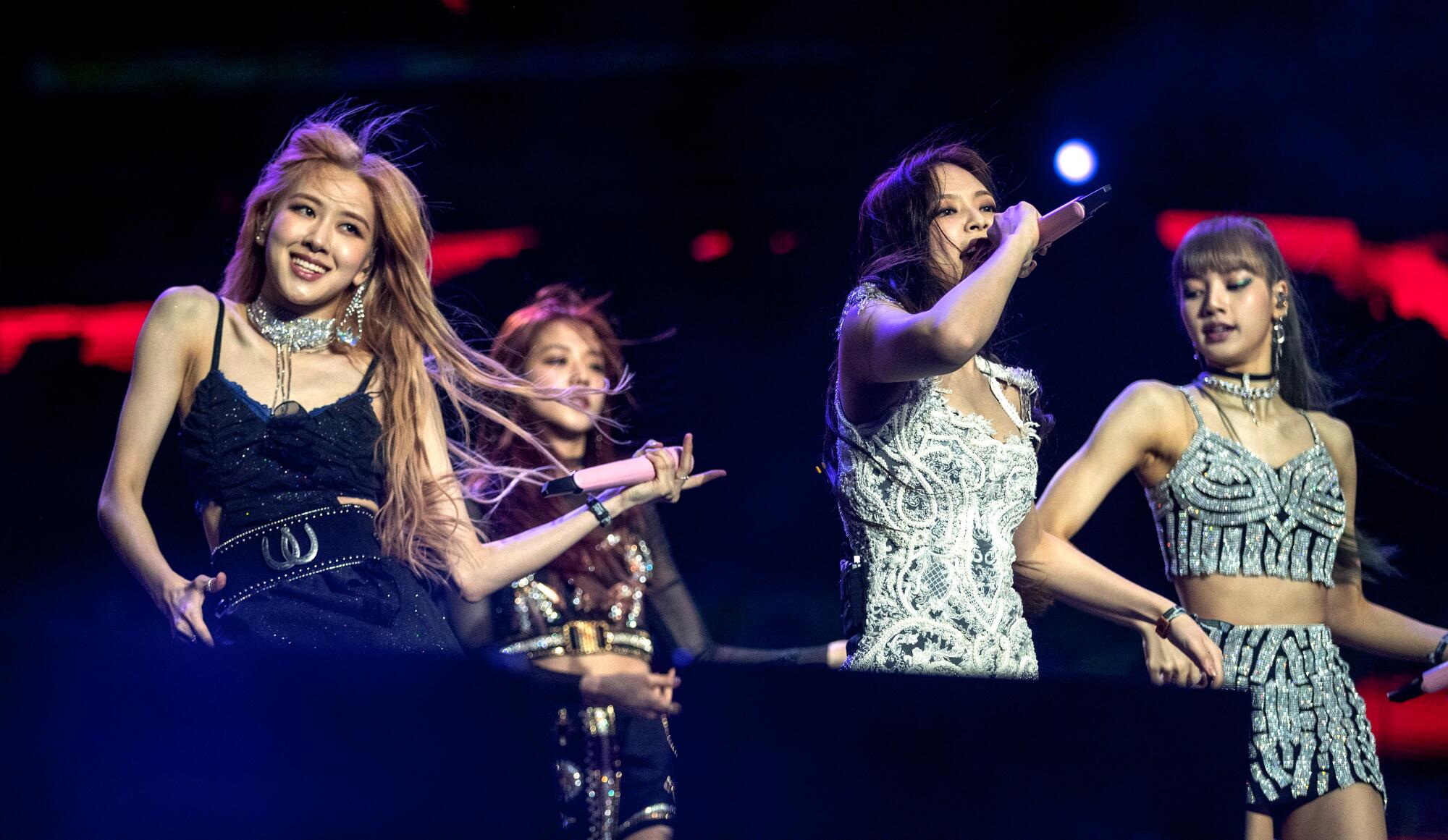 A female K-pop foursome performs onstage