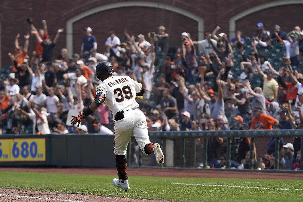 Fans cheer as San Francisco Giants' Thairo Estrada (39) rounds the bases after hitting a three-run home run against the Milwaukee Brewers during the eighth inning of a baseball game in San Francisco, Thursday, Sept. 2, 2021. (AP Photo/Jeff Chiu)