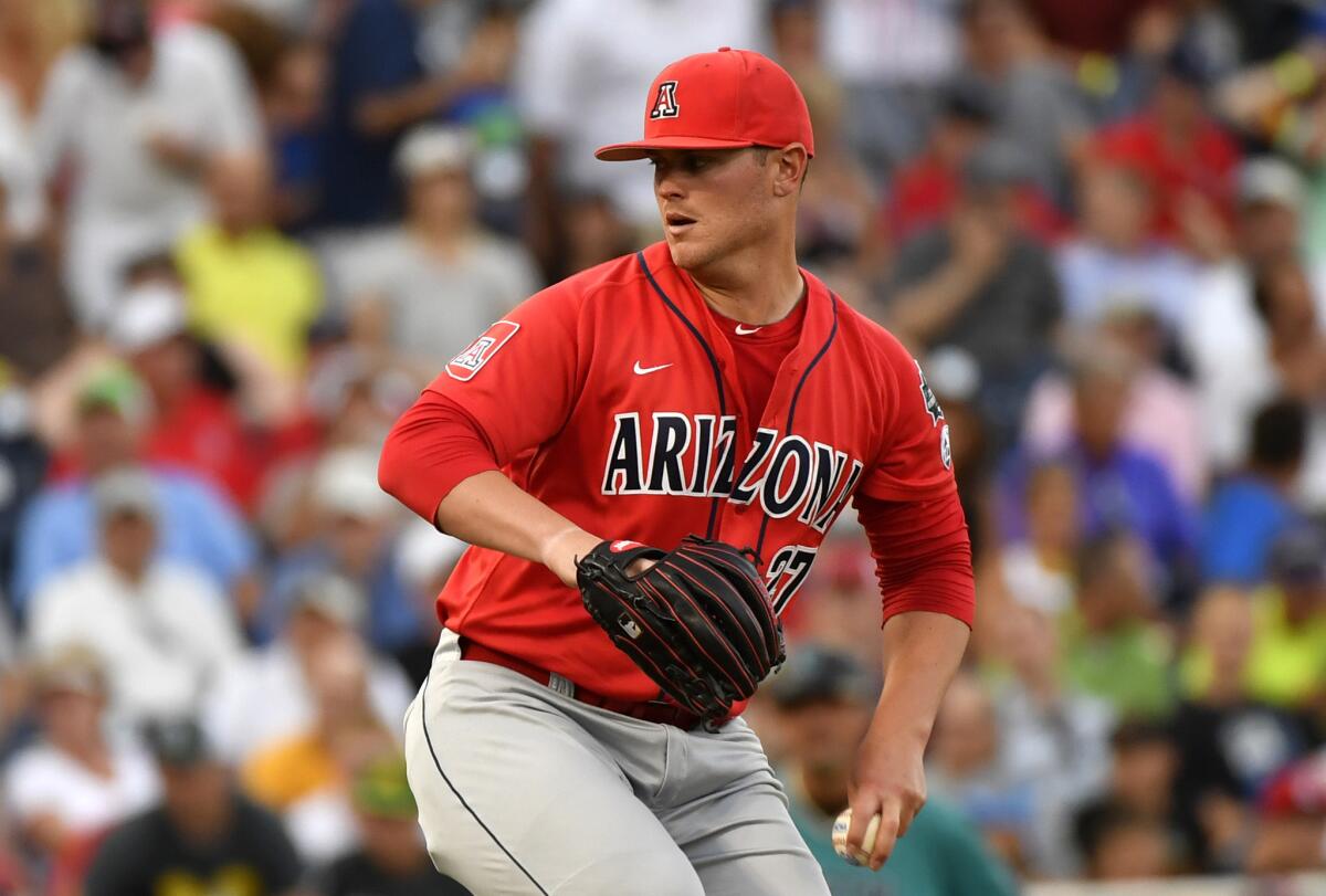 Arizona pitcher JC Cloney (27) works against Coastal Carolina in the seventh inning in Game 1 of the College World Series finals.